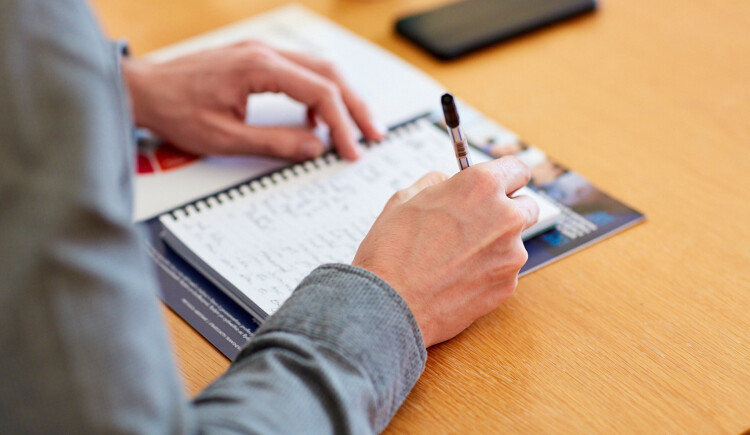 Person writing in a notebook